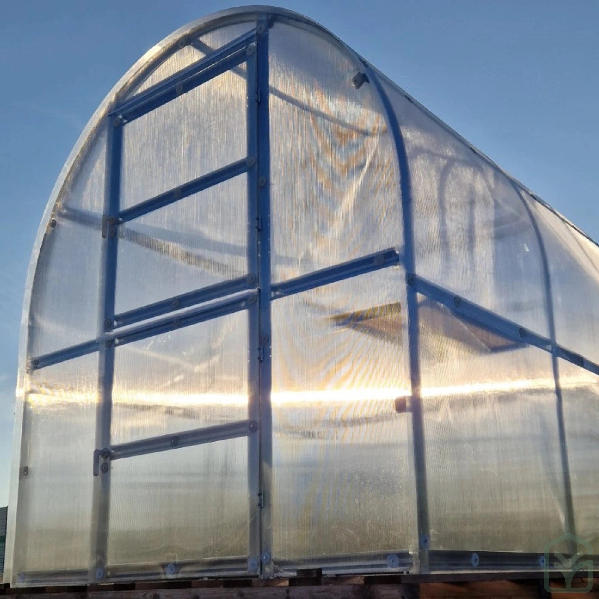 Mini greenhouse from the exterior with closed doors and window