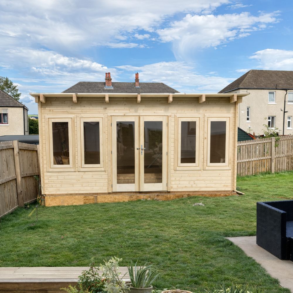 Wooden shed with glass doors and windows in a backyard setting.