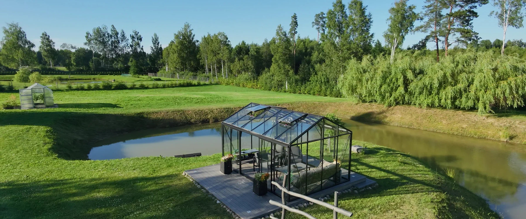 Greenhouse by a pond at golden hour