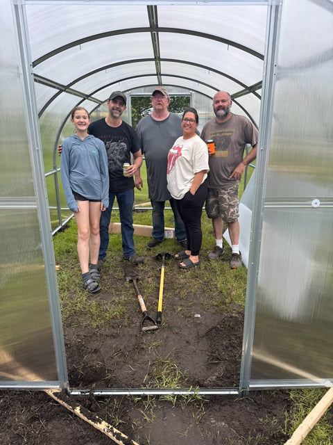 A polycarbonate greenhouse in an owner's garden