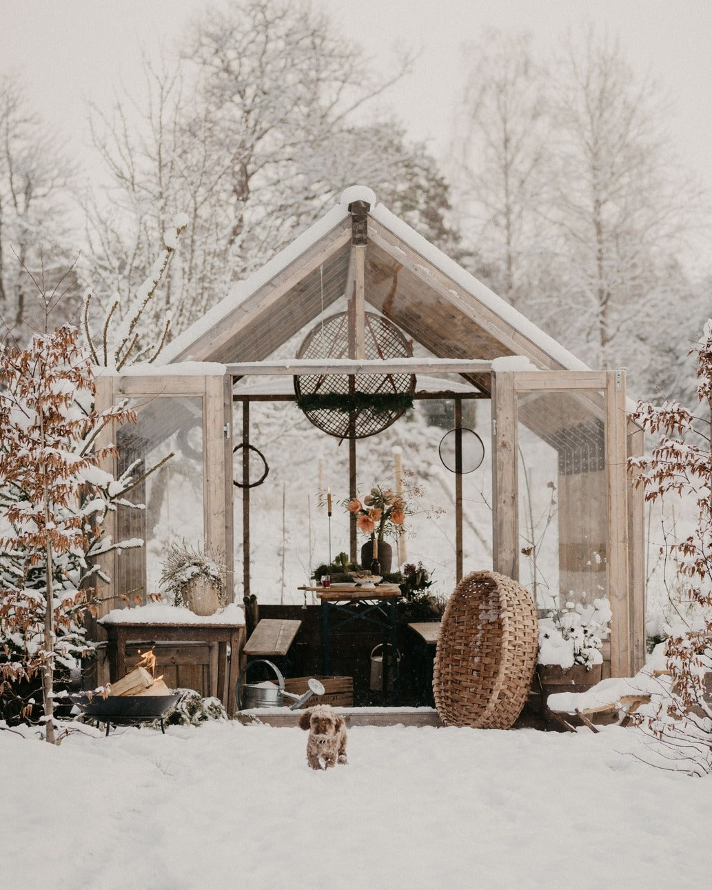 Wooden shed in a snowy landscape with decorative items inside