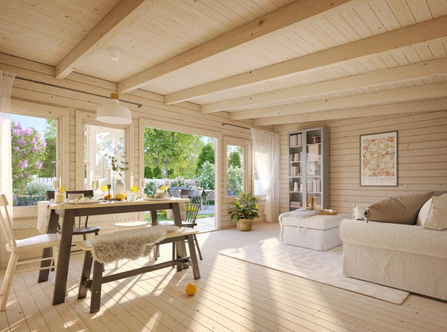 Wooden interior of a cabin with a dining table and living area.
