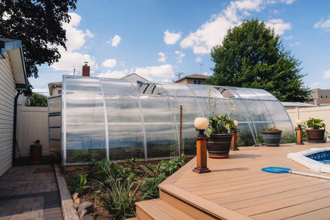 A polycarbonate greenhouse in an owner's garden