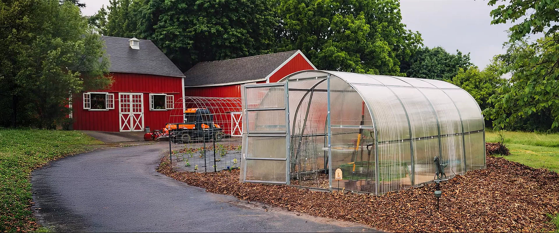 Polycarbonate greenhouse in a backyard garden