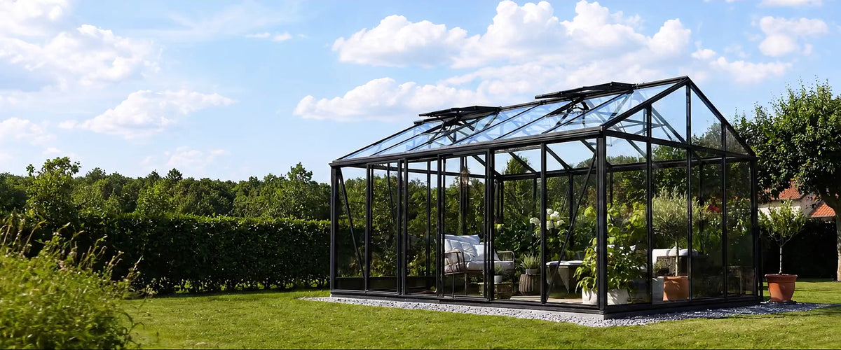 Glass greenhouse in a landscaped garden