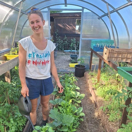 A polycarbonate greenhouse in an owner's garden
