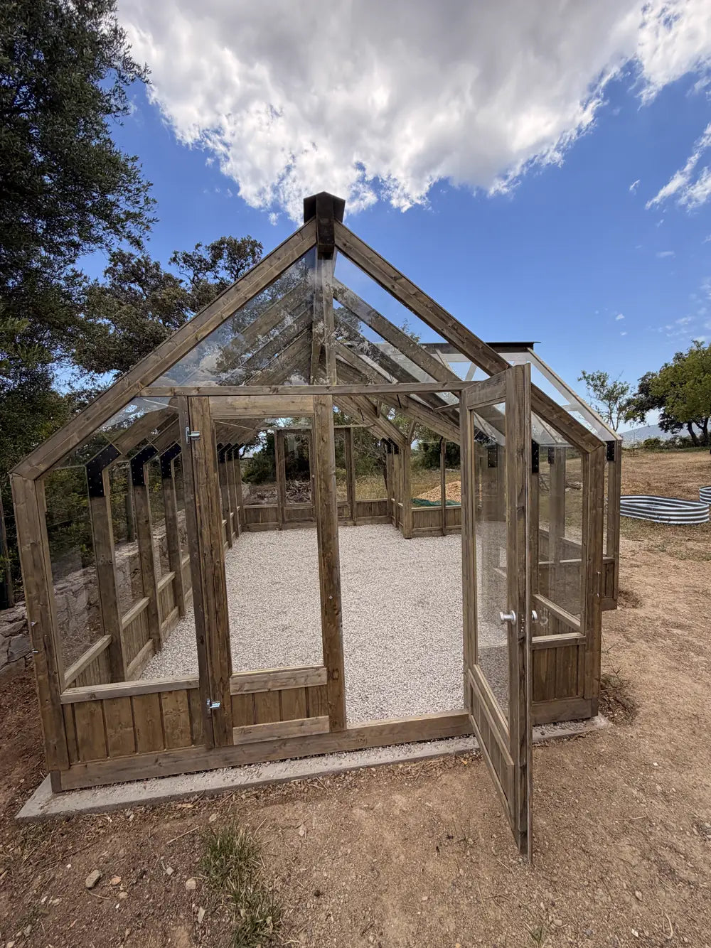 Low angle of a wooden greenhouse against open sky